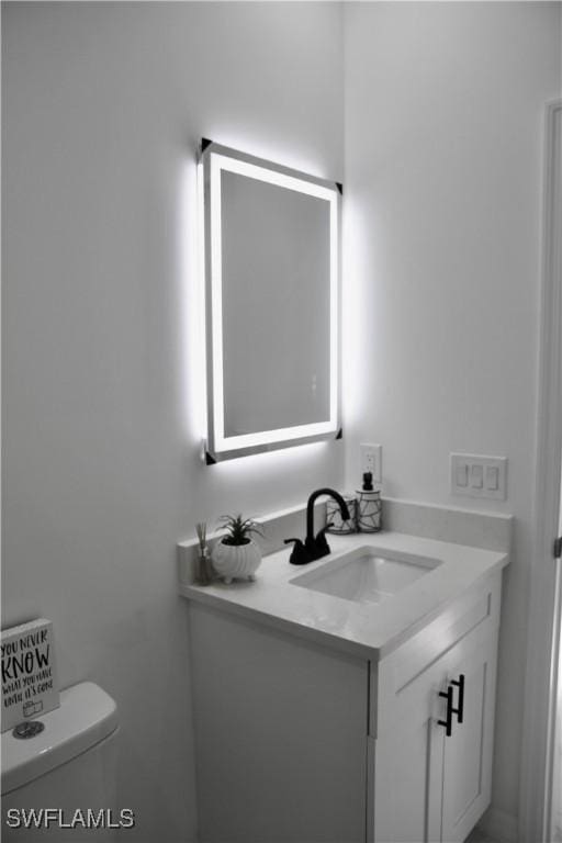 bathroom featuring vanity and toilet