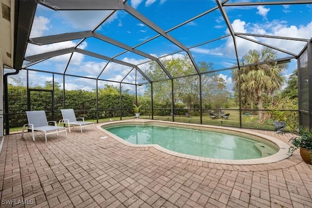 view of pool featuring a patio and glass enclosure