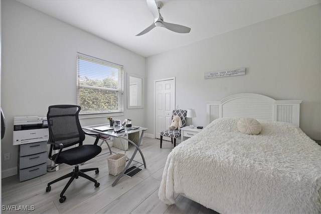 bedroom with light hardwood / wood-style flooring, a closet, and ceiling fan