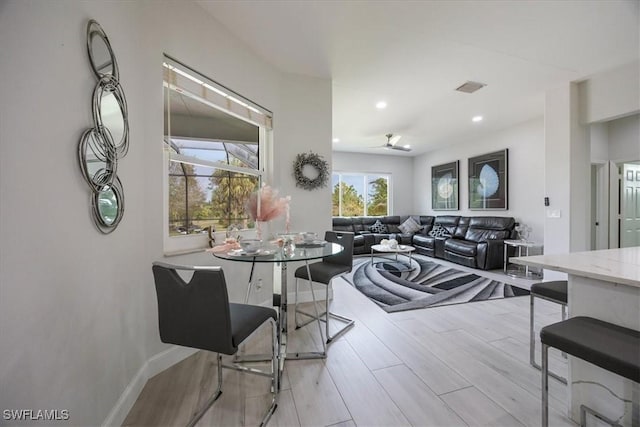 dining space featuring ceiling fan and light hardwood / wood-style flooring