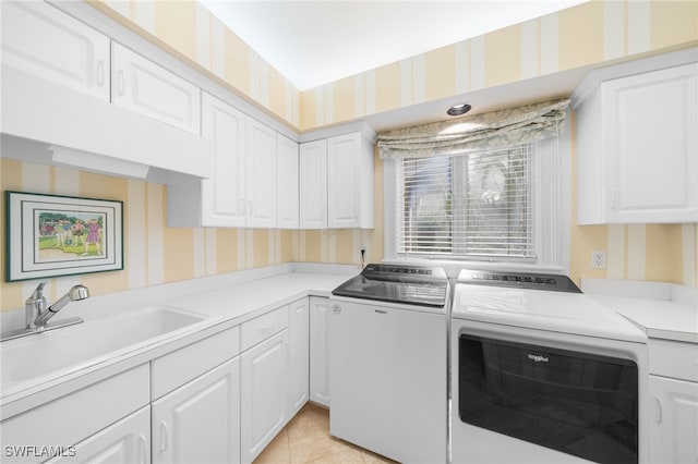 laundry room featuring cabinets, sink, light tile patterned flooring, and washer and dryer