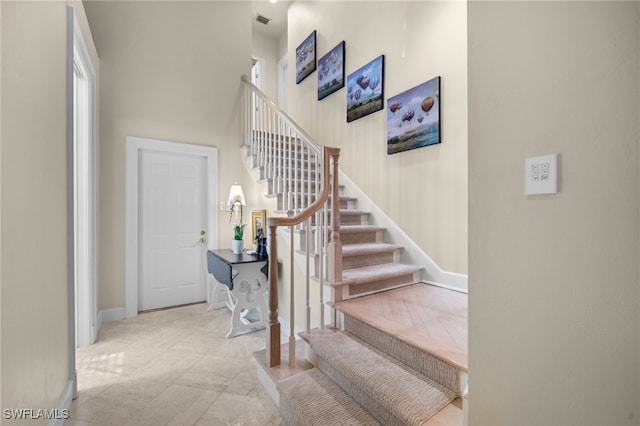 stairs featuring tile patterned flooring