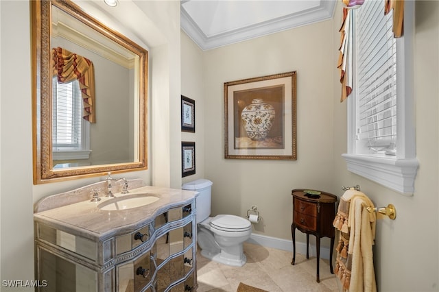 bathroom with tile patterned flooring, vanity, toilet, and ornamental molding