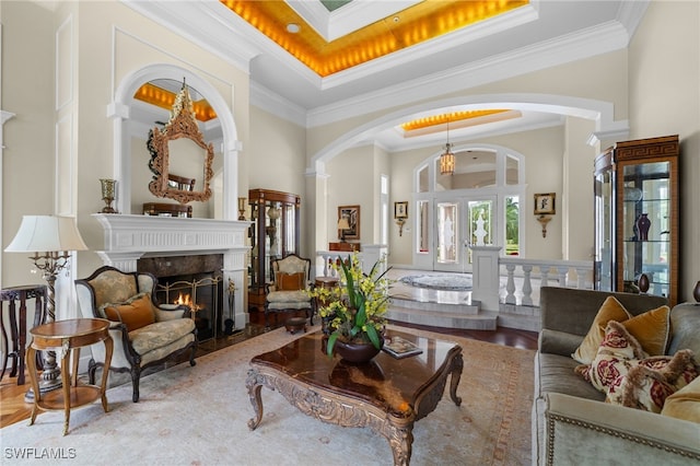 living room featuring ornamental molding and a tray ceiling