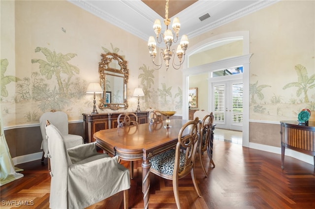 dining room with a chandelier, french doors, dark parquet floors, and crown molding