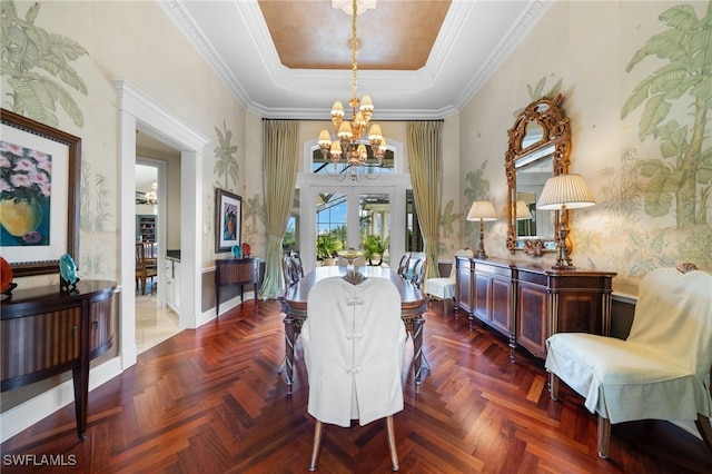 living area with french doors, ornamental molding, parquet flooring, a tray ceiling, and a notable chandelier