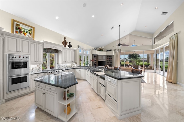 kitchen with a center island, high vaulted ceiling, double oven, kitchen peninsula, and decorative backsplash