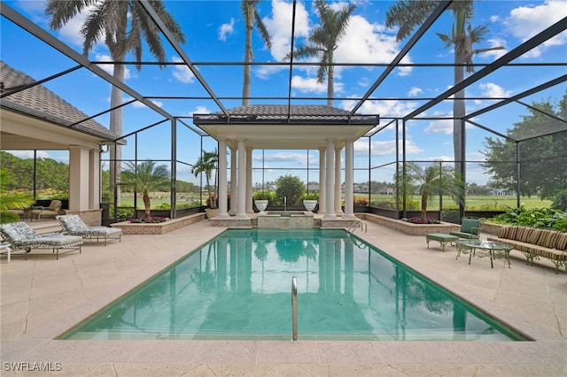 view of pool with a lanai, a patio area, and an in ground hot tub