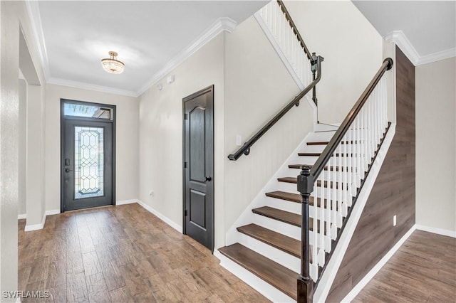 entrance foyer featuring crown molding, hardwood / wood-style floors, and an inviting chandelier