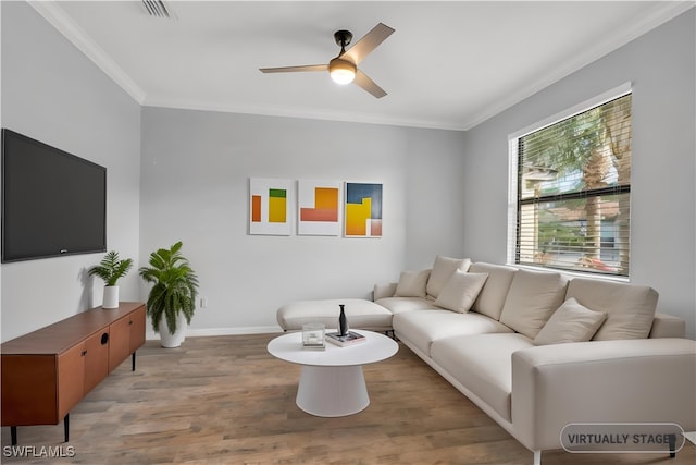 living room with hardwood / wood-style flooring, ceiling fan, and crown molding