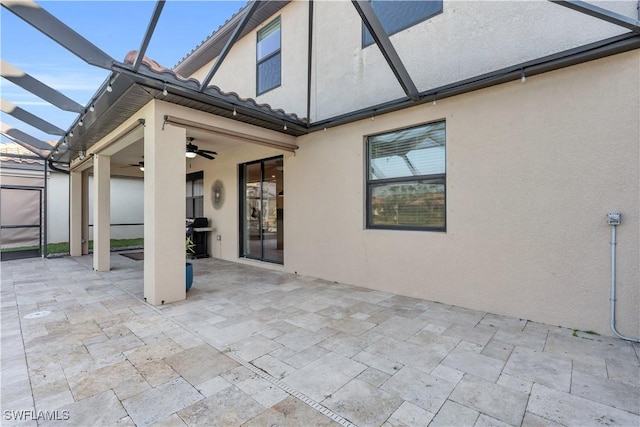 rear view of house featuring a lanai, ceiling fan, and a patio area