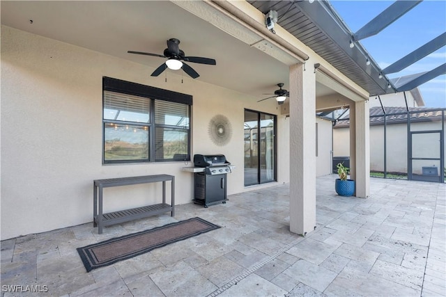 view of patio / terrace featuring glass enclosure, ceiling fan, and a grill