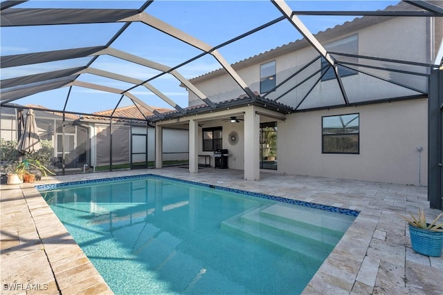 pool featuring a lanai, grilling area, a ceiling fan, and a patio