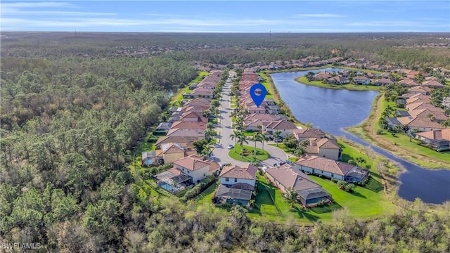 aerial view with a water view, a residential view, and a wooded view