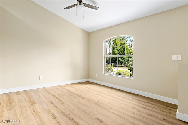 spare room with a ceiling fan, wood finished floors, and baseboards