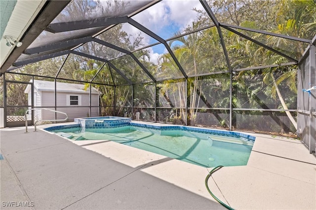 view of swimming pool featuring a pool with connected hot tub, a lanai, a storage shed, a patio area, and an outbuilding