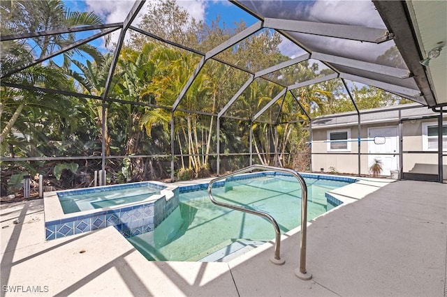 view of swimming pool with a patio, a pool with connected hot tub, and a lanai