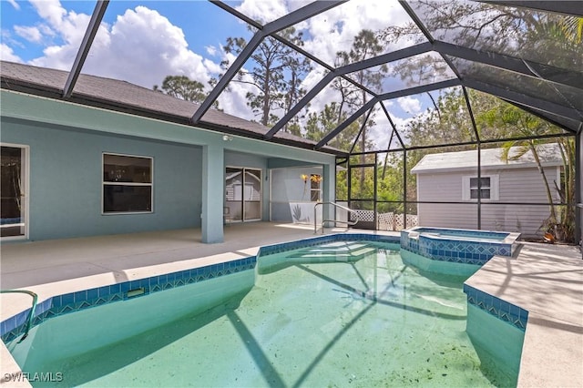 view of pool with glass enclosure, a pool with connected hot tub, and a patio