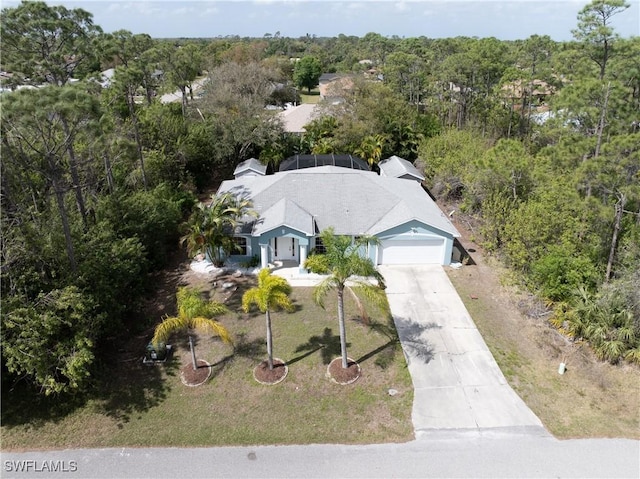 birds eye view of property with a forest view