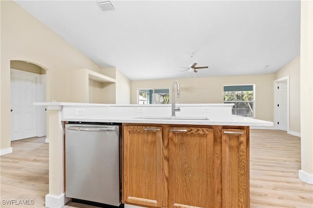 kitchen with visible vents, a sink, stainless steel dishwasher, light countertops, and lofted ceiling