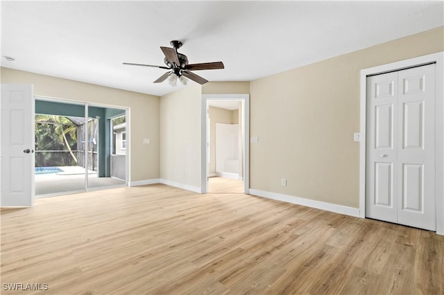 interior space with access to exterior, ensuite bathroom, baseboards, and light wood finished floors