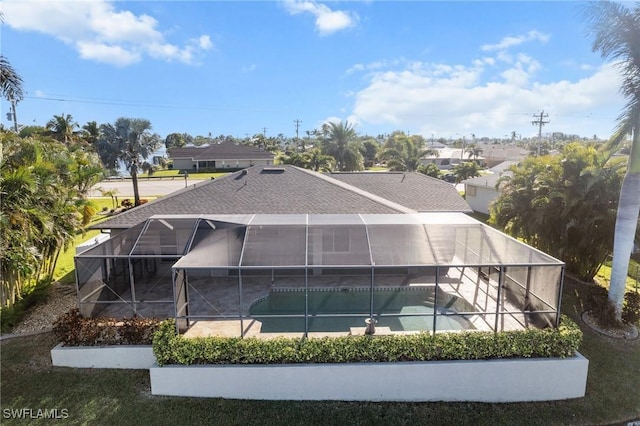 back of house featuring a patio area and a lanai