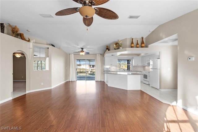 unfurnished living room featuring light hardwood / wood-style floors and vaulted ceiling