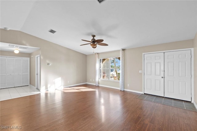 unfurnished living room featuring ceiling fan, light hardwood / wood-style floors, and vaulted ceiling