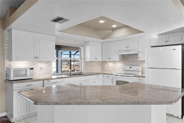 kitchen featuring white appliances, sink, white cabinets, a large island, and light tile patterned flooring