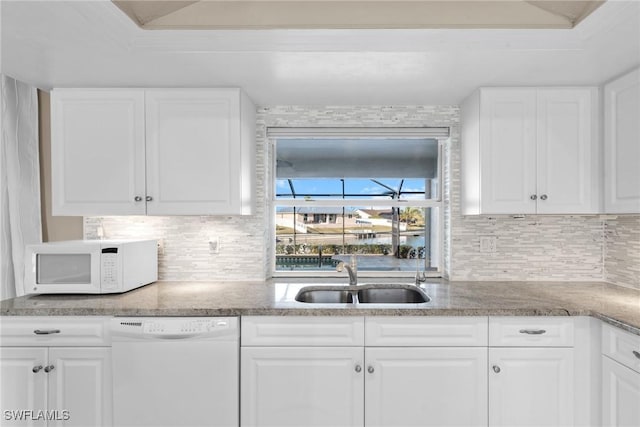 kitchen with sink, white cabinets, and white appliances