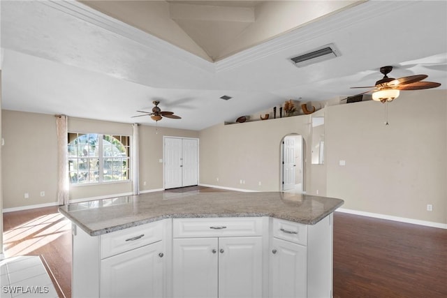 kitchen featuring light stone countertops, hardwood / wood-style floors, white cabinetry, and ceiling fan