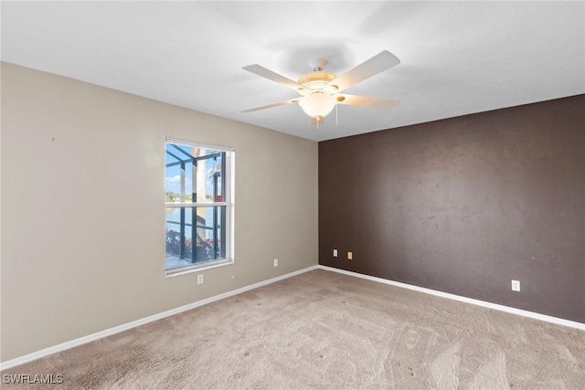 spare room featuring ceiling fan and carpet floors