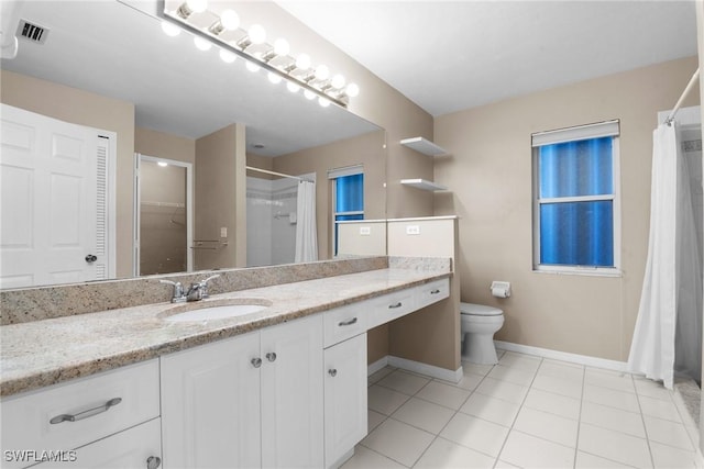 bathroom with tile patterned flooring, vanity, and toilet