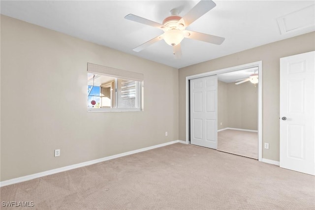 unfurnished bedroom with light colored carpet, a closet, and ceiling fan