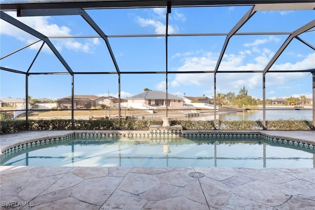 view of pool featuring a lanai, a water view, and a patio