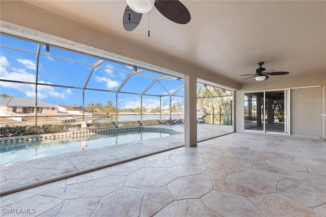 view of swimming pool featuring ceiling fan, a lanai, a patio, and a water view