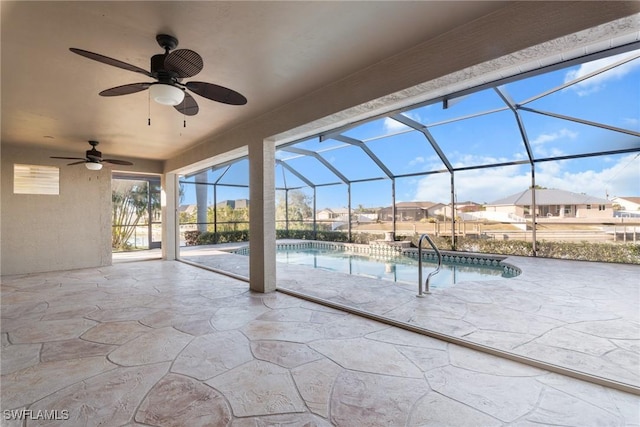 view of patio featuring glass enclosure and ceiling fan