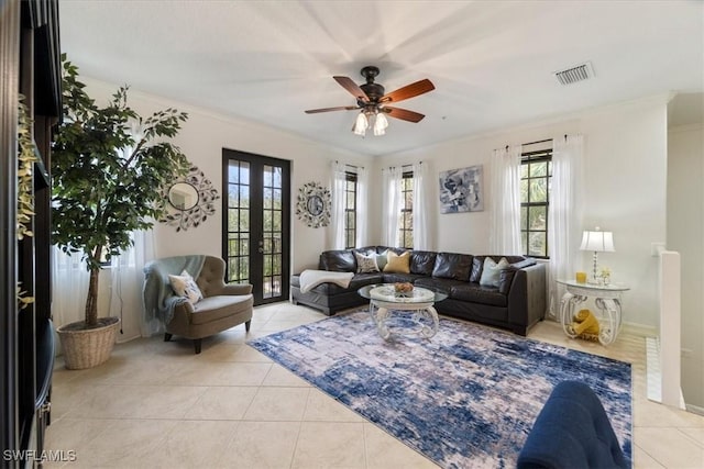 living room with french doors, light tile patterned floors, ceiling fan, and crown molding