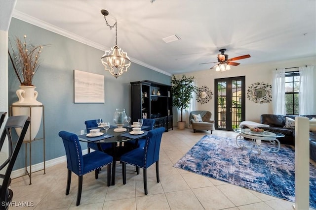 tiled dining space with ceiling fan with notable chandelier and ornamental molding