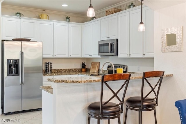 kitchen with kitchen peninsula, white cabinets, and stainless steel appliances