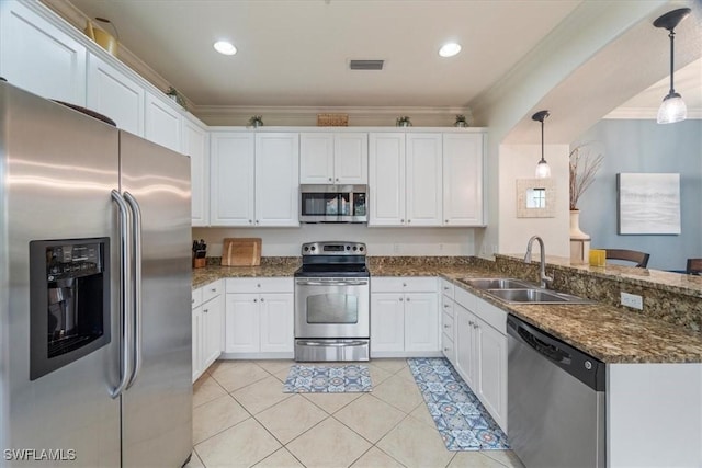 kitchen with white cabinets, decorative light fixtures, sink, and appliances with stainless steel finishes