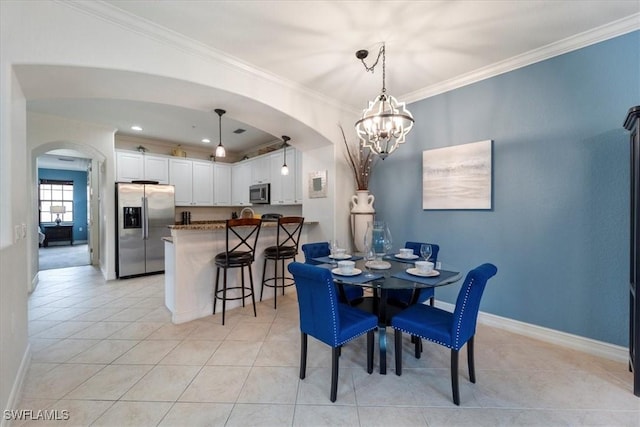 tiled dining room with crown molding and an inviting chandelier