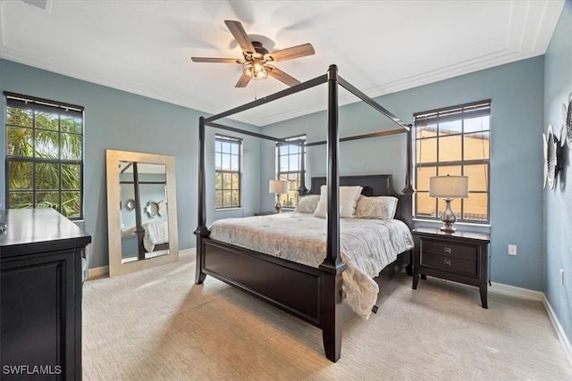 carpeted bedroom featuring ceiling fan and crown molding