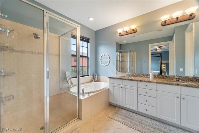 bathroom with tile patterned floors, vanity, and separate shower and tub