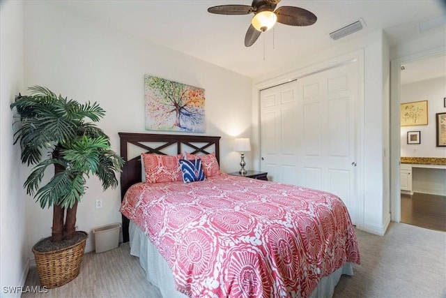 bedroom featuring ceiling fan, ensuite bath, and a closet