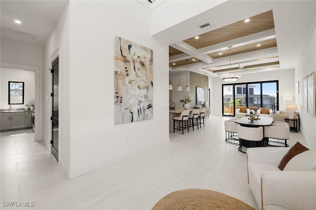 hall with beam ceiling, sink, wooden ceiling, and an inviting chandelier