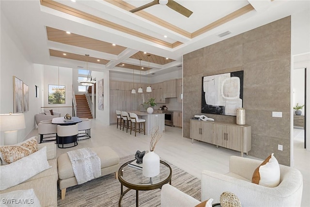 living room featuring beam ceiling and ceiling fan