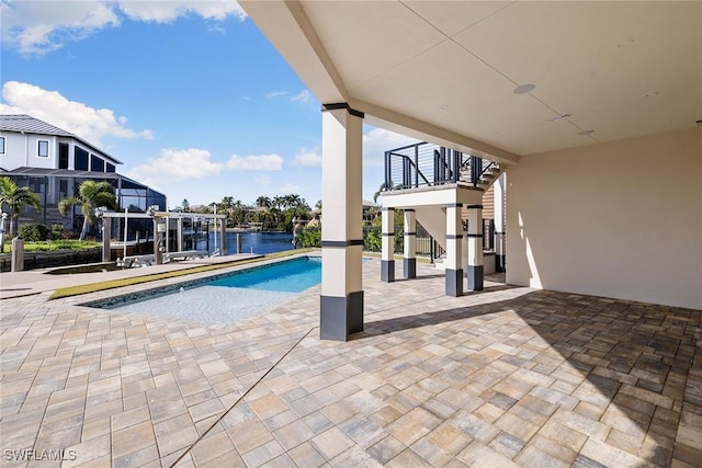 view of pool featuring a patio and a water view