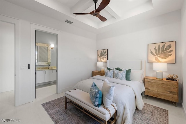 bedroom featuring ceiling fan, a raised ceiling, and ensuite bath