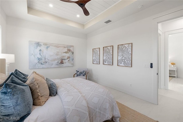 bedroom with a tray ceiling and ceiling fan